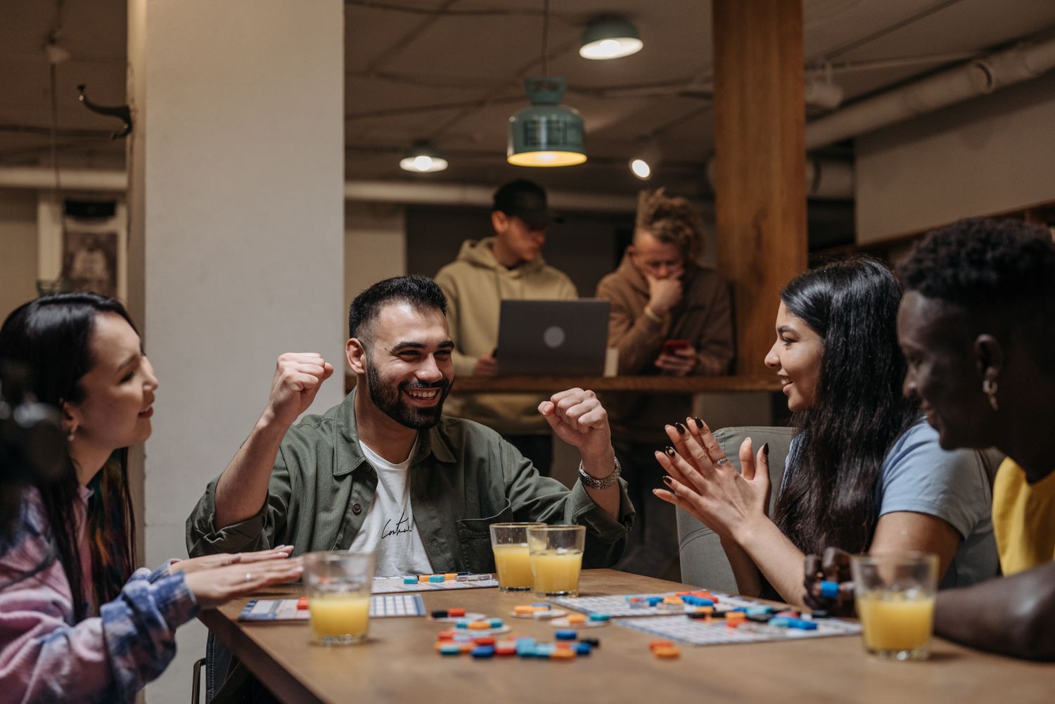 A group of friends playing a board game indoors, enjoying fun and laughter.