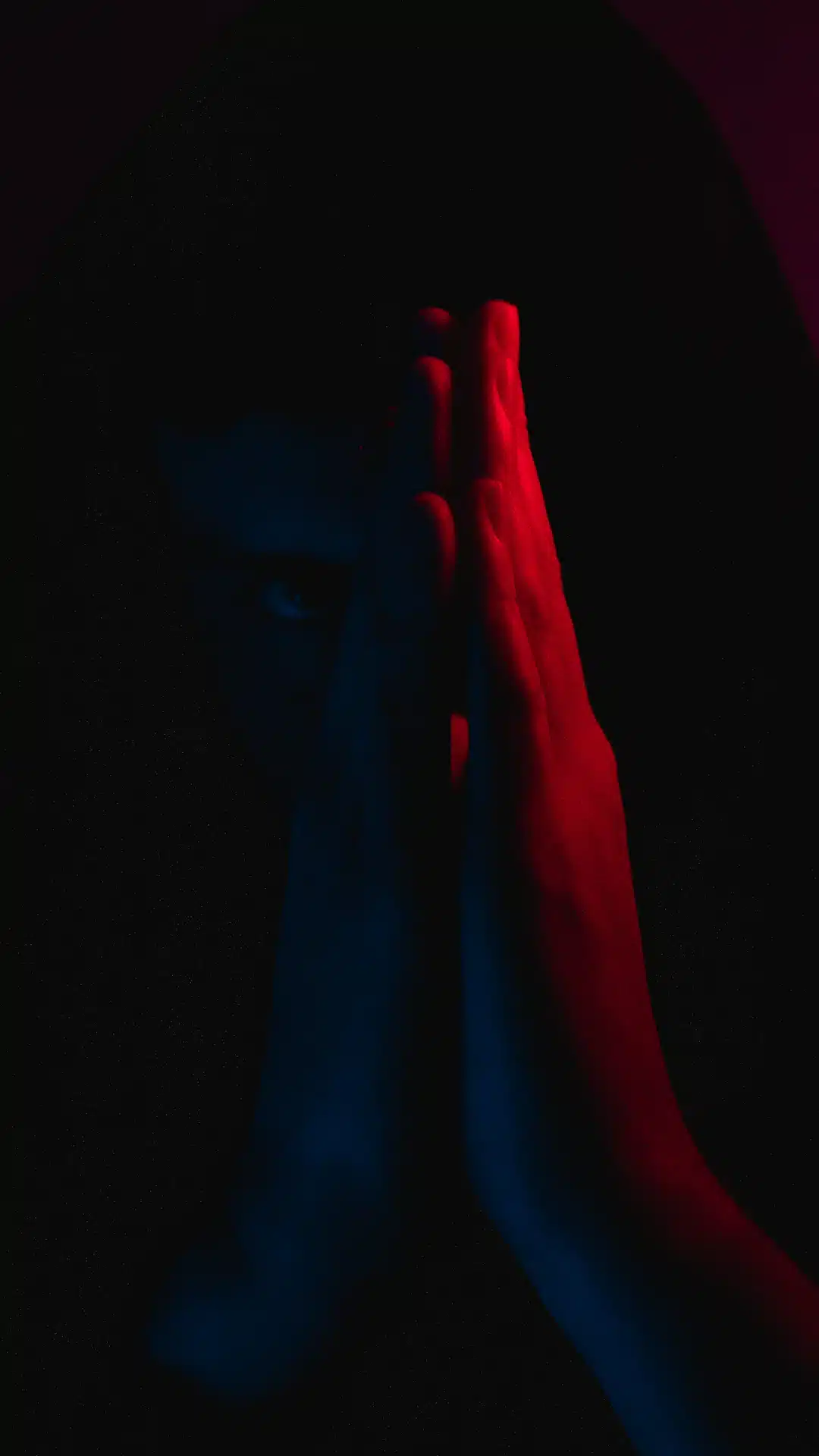 a person covering their face with their hands