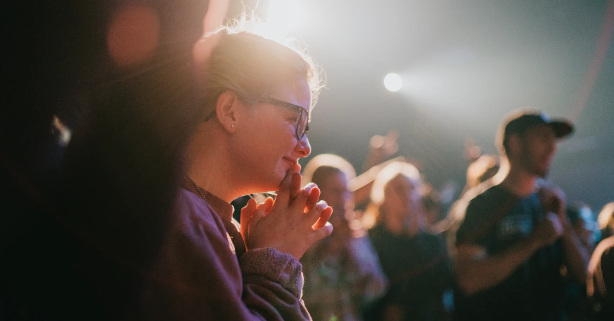 selective focus photography of woman praying